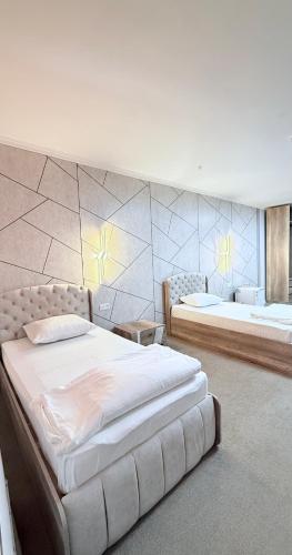 a bedroom with two beds in a room at Sultan Saray in Türkistan