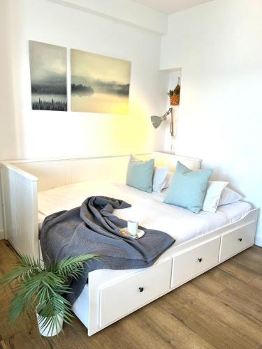 a white bed with a blanket on it in a room at Studio on the Beach Front in Sitio de Calahonda