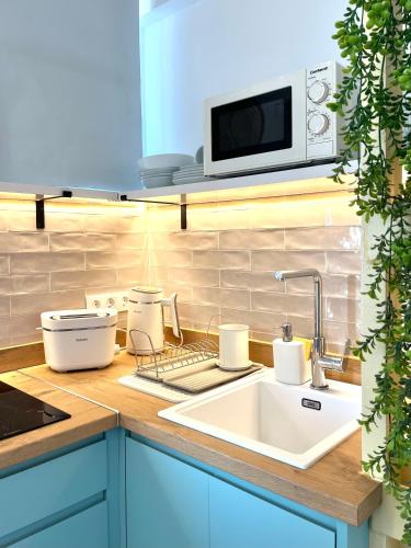 a kitchen with a sink and a microwave at Studio on the Beach Front in Sitio de Calahonda