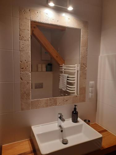 a bathroom with a sink and a mirror at Chata Balówka in Cisna