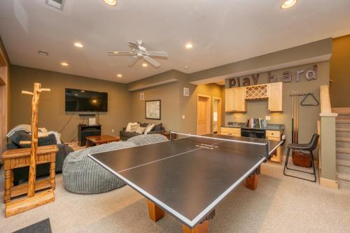 a living room with a ping pong table at Chubby Bunny Lodge by Railey Vacations in McHenry