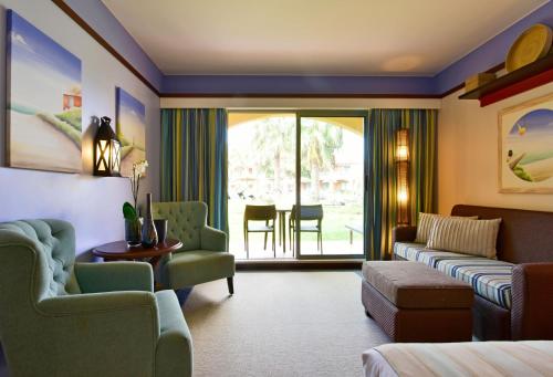 a living room with a couch and chairs and a table at Pestana Porto Santo Premium All Inclusive Beach & SPA Resort in Porto Santo
