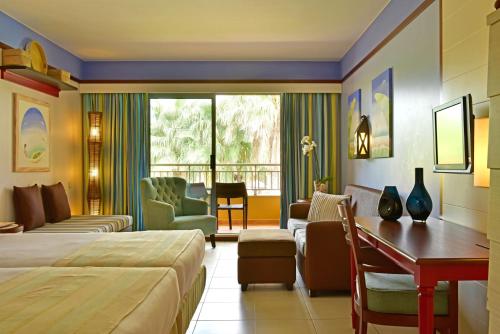a hotel room with a bed and a desk at Pestana Porto Santo Beach Resort & SPA in Porto Santo