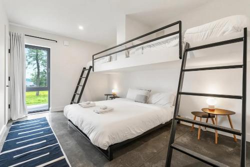 a bedroom with a bunk bed with a ladder at Lake Bomoseen - Lake Access, Fire Pit & BBQ in Castleton
