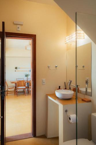 a bathroom with a sink and a dining room at Vila Harmonia sua casa na Praia do Preá in Prea