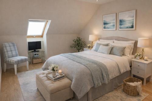 a bedroom with a large bed and a chair at Crayford's Guest House in Aberdeen
