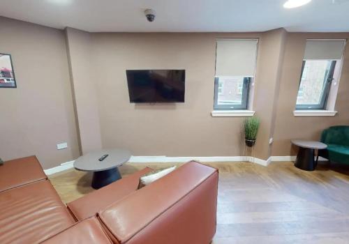 a living room with a couch and a table at iQ Parker House Dundee in Dundee