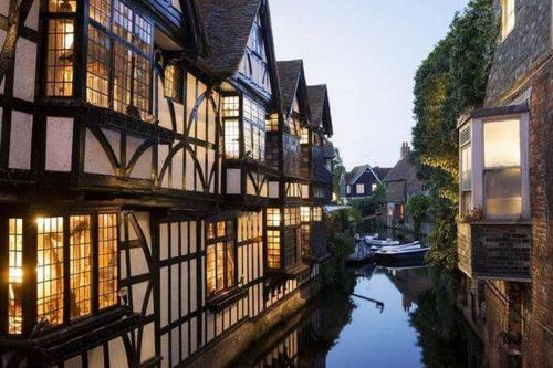 a view of a canal with buildings and a river at Augustines Cottage, Canterbury centre Free Parking in Canterbury