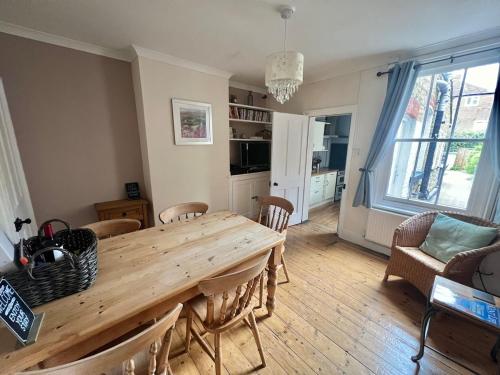 a dining room with a wooden table and chairs at Augustines Cottage, Canterbury centre Free Parking in Canterbury
