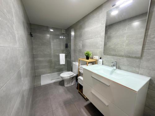 a bathroom with a white sink and a toilet at LOFT La Palma in Almería