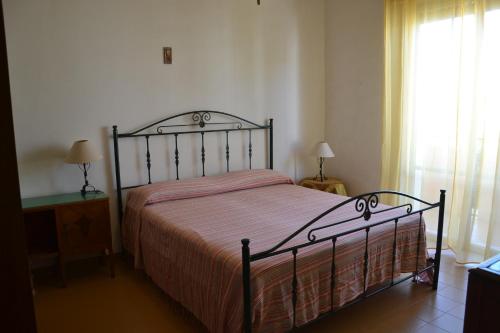 um quarto com uma cama e uma janela com cortinas em Da Nino e Maria em Marina di Modica