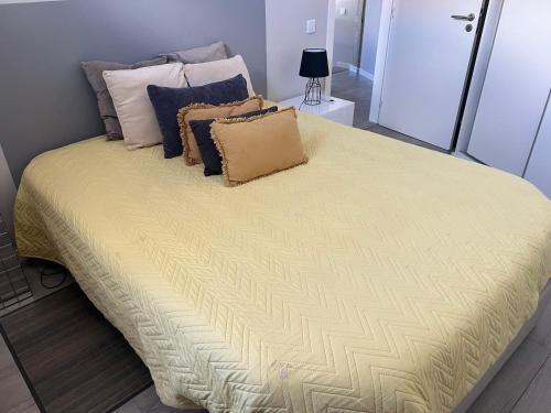 a large bed with pillows on it in a room at Al Amoreirinha Rui Barata in Castelo Branco