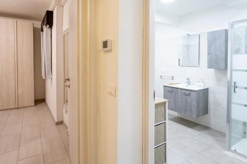 a white bathroom with a sink and a shower at Casa Cesari in Ponte Ronca