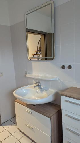 a bathroom with a sink and a mirror at Red Dot Apartment Lucky in Kamen