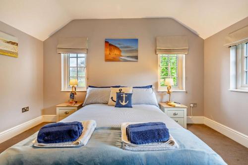 a bedroom with a bed with two blue towels on it at 2 Bed in Uplyme oc-s28314 in Uplyme