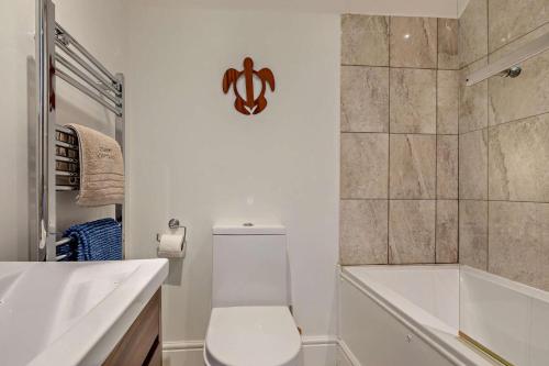 a white bathroom with a toilet and a shower at 2 Bed in Uplyme oc-s28314 in Uplyme