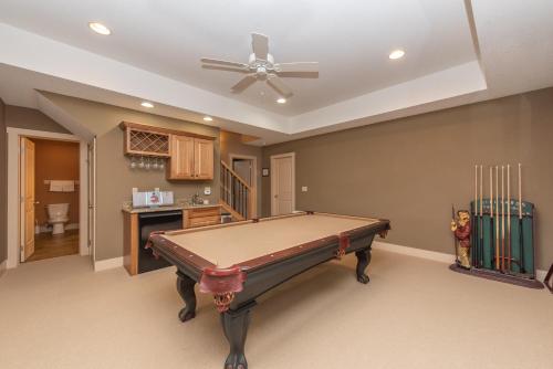a pool table in a room with a ceiling fan at Restful Retreat by Railey Vacations in Oakland