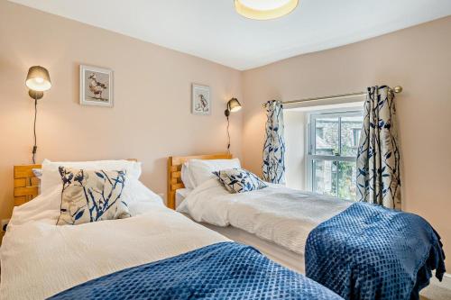 two beds in a room with a window at 2 Bed in Ormathwaite oc-s32385 in Applethwaite