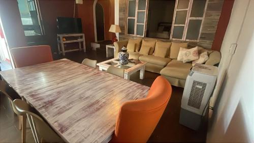 a living room with a wooden table and a couch at Hotel Kasa Sarita Centro Historico SMA in San Miguel de Allende