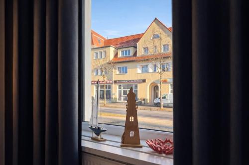 a window with a view of a street and a building at FRAME by Tendo Stay - Comfort Housing in Falkensee