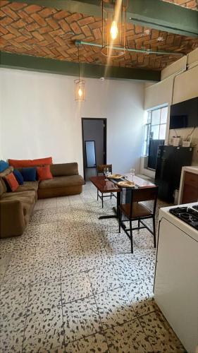 a living room with a couch and a table at Hotel Kasa Sarita Centro Historico SMA in San Miguel de Allende