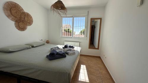a bedroom with a bed with towels on it at Casa Amis Calpe in Calpe