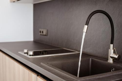a kitchen with a sink with a faucet at Aelia Kastraki Beach House in Kastraki