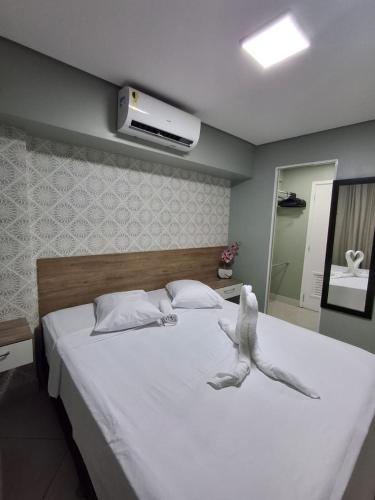 a bedroom with a large bed with a stuffed animal on it at Apart 203 Vista Mar in Fortaleza