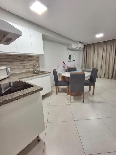 a kitchen and dining room with a table and chairs at Apart 203 Vista Mar in Fortaleza