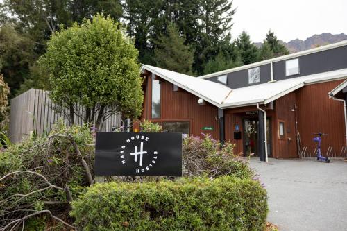 a building with a sign in front of it at Haka House Queenstown Lakefront in Queenstown