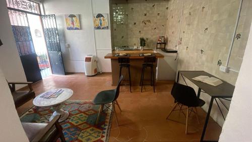a kitchen with a sink and a table and chairs at Hotel Kasa Sarita Centro Historico SMA in San Miguel de Allende