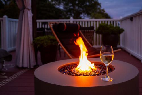 a glass of wine sitting on a table next to a fire at Lindenwood Inn in Southwest Harbor