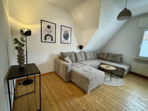 a living room with a couch and a table at Altstadt Apartment Deluxe 3 in Haltern