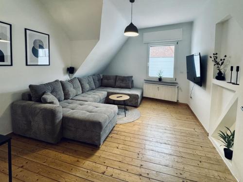 a living room with a couch and a table at Altstadt Apartment Deluxe 3 in Haltern