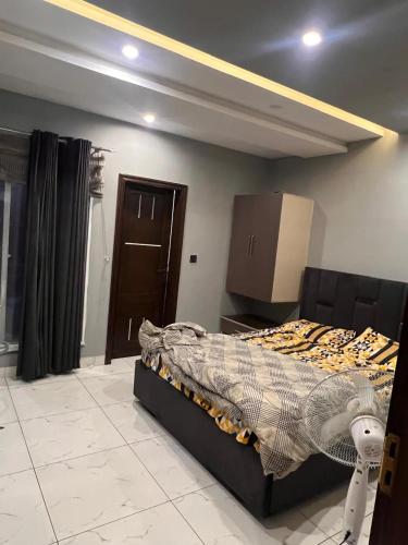 a bedroom with a bed in a room at HNC Arcade in Dargai