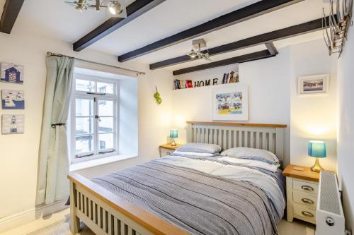 a bedroom with a bed and a window at 1 Bed in Looe oc-l30002 in Looe