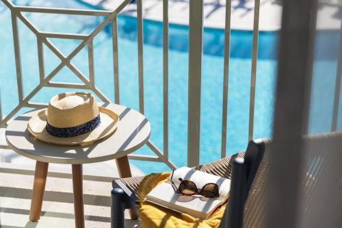a hat and sunglasses sitting on a chair next to a pool at SpringHill Suites by Marriott Orange Beach Gulf Shores in Orange Beach