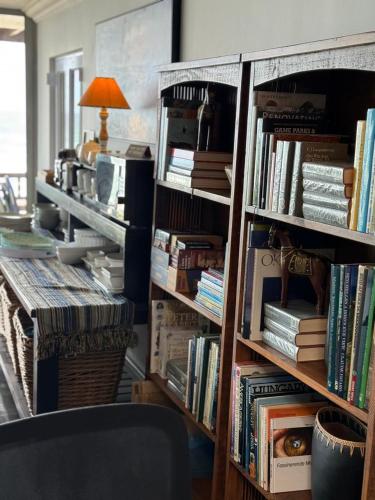 a book shelf filled with lots of books at Sea Paradise in Wilderness