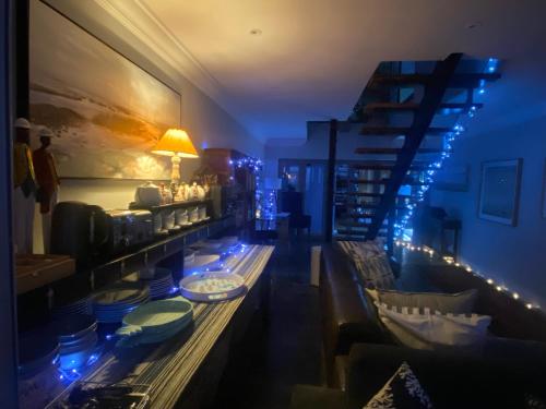 a living room with a long table with dishes on it at Sea Paradise in Wilderness