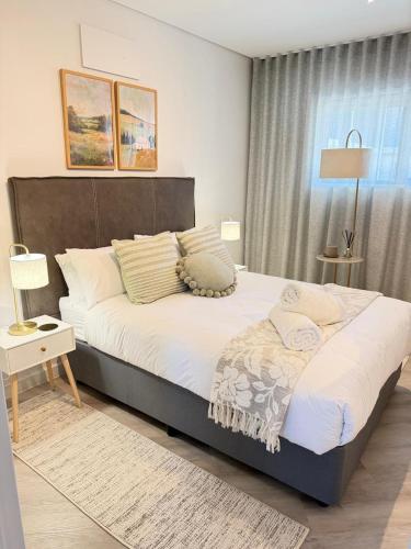 a bedroom with a large bed and a window at Platform 123 - 2 On Tabak with onsite Parking in Paarl