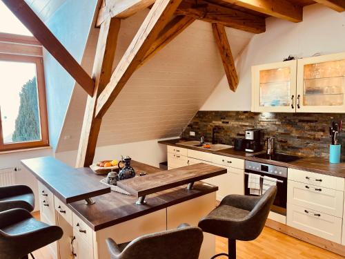 a kitchen with a wooden table and some chairs at Badischhaus am Waldrand & Weitblick in Herrischried