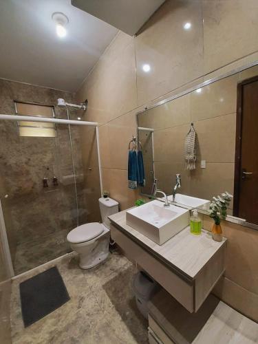 a bathroom with a sink and a toilet and a shower at Casa da Colina Curitiba com piscina in Curitiba