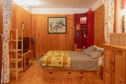 a bedroom with a bed and wooden walls at Prali Ski House - 4beds - Parking - Garden in Prali