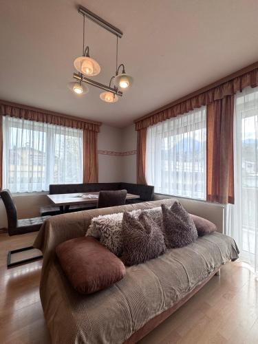 a couch with pillows on it in a living room at Fewos Wuzella Faaker See in Latschach