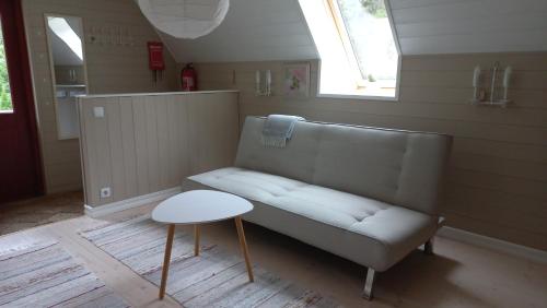 a living room with a bench and a table at Lohusalu Apartment in Lohusalu