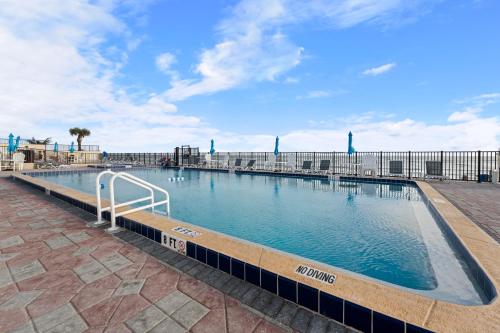 a large swimming pool in the middle of a building at Outrigger Beach Club Resort by CoolVacay in Ormond Beach