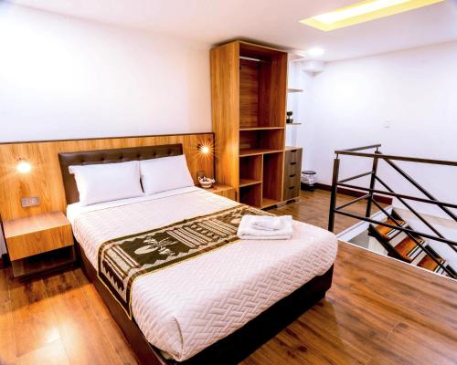 a bedroom with a bed and a book shelf at Hotel Casa Santiago in Pasto