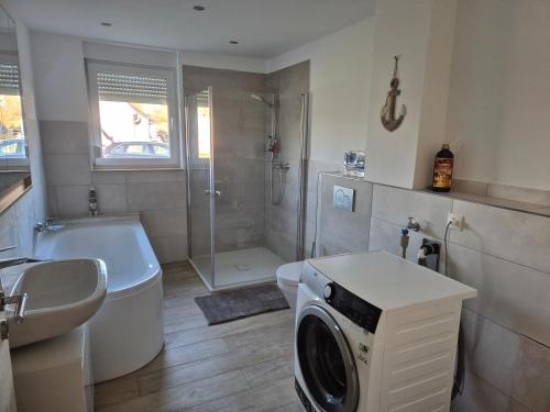 a bathroom with a washing machine in a sink at Lewitz-Urlaub in Lübesse