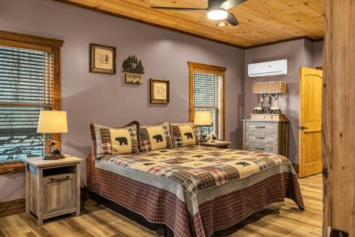 a bedroom with a bed and a dresser at Tellico River Retreat in Tellico Plains