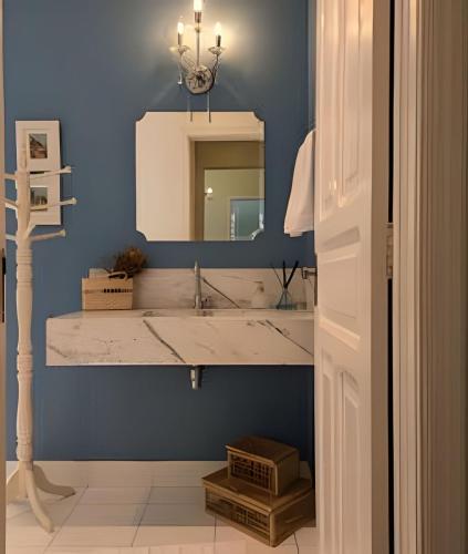 a bathroom with a sink and a mirror at SHB - Beach House with Air Conditioning in Santos